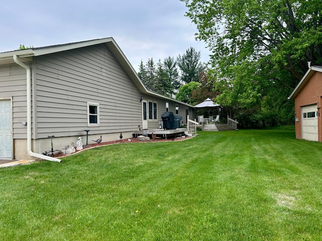 10696 Leaf River Rd, Leaf River Twp, MN 56482 - view of green lawn with a deck and a garage