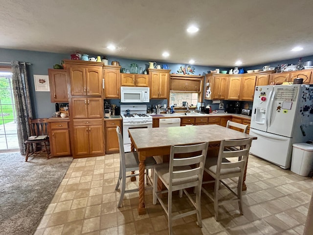10696 Leaf River Rd, Leaf River Twp, MN 56482 - kitchen featuring white appliances, light countertops, recessed lighting, brown cabinetry, and a center island