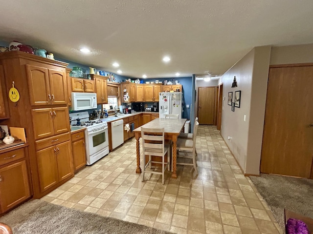 10696 Leaf River Rd, Leaf River Twp, MN 56482 - kitchen with white appliances, brown cabinetry, a breakfast bar area, a center island, and light countertops