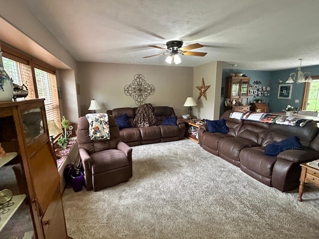 10696 Leaf River Rd, Leaf River Twp, MN 56482 - living area featuring carpet flooring, a ceiling fan, and a chandelier