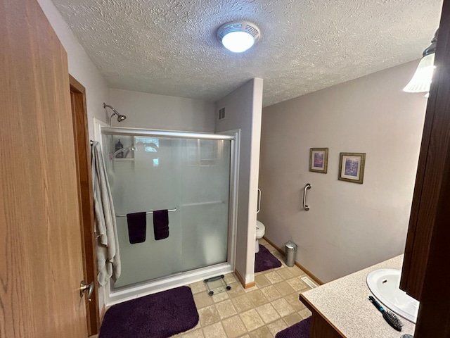 10696 Leaf River Rd, Leaf River Twp, MN 56482 - full bath featuring vanity, a stall shower, toilet, a textured ceiling, and baseboards