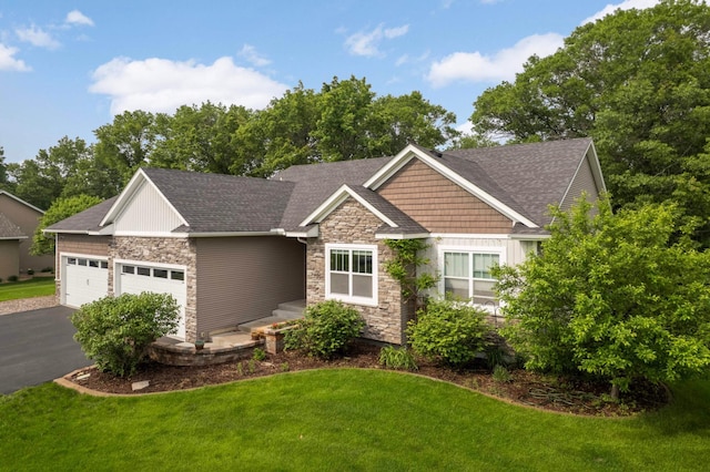 2349 175th Ln NE, Ham Lake, MN 55304 - craftsman inspired home with stone siding, an attached garage, asphalt driveway, a front yard, and roof with shingles