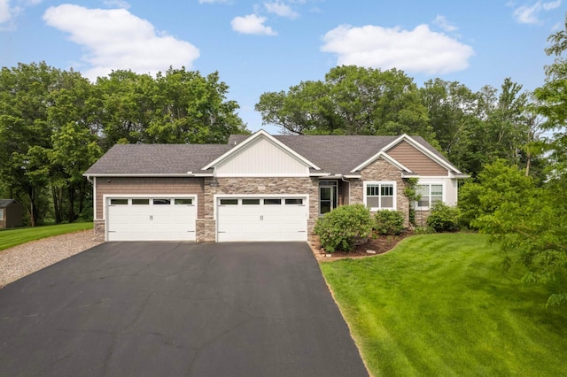 2349 175th Ln NE, Ham Lake, MN 55304 - view of front of property with stone siding, driveway, a garage, and a front lawn