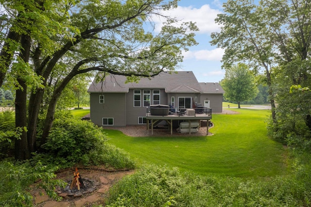 2349 175th Ln NE, Ham Lake, MN 55304 - back of property featuring a fire pit, a deck, a lawn, and a shingled roof
