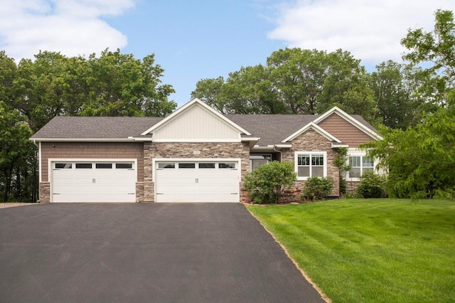 2349 175th Ln NE, Ham Lake, MN 55304 - craftsman-style house with stone siding, an attached garage, and driveway