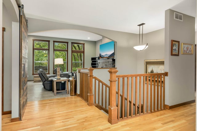 2349 175th Ln NE, Ham Lake, MN 55304 - hallway with an upstairs landing, light wood-style floors, baseboards, and arched walkways