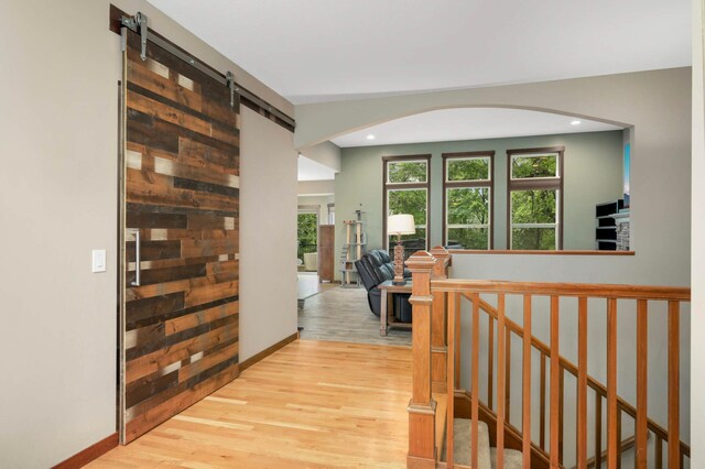 2349 175th Ln NE, Ham Lake, MN 55304 - hall with wood finished floors, recessed lighting, arched walkways, a barn door, and baseboards