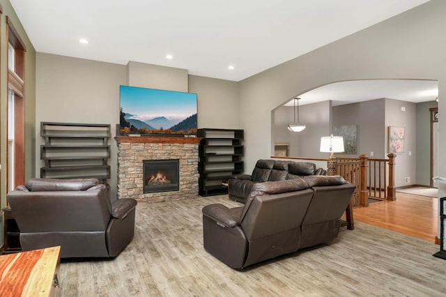 2349 175th Ln NE, Ham Lake, MN 55304 - living area with light wood-style floors, arched walkways, a fireplace, and recessed lighting