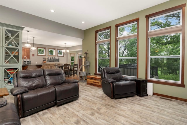 2349 175th Ln NE, Ham Lake, MN 55304 - living area featuring light wood-style flooring, recessed lighting, a chandelier, and baseboards