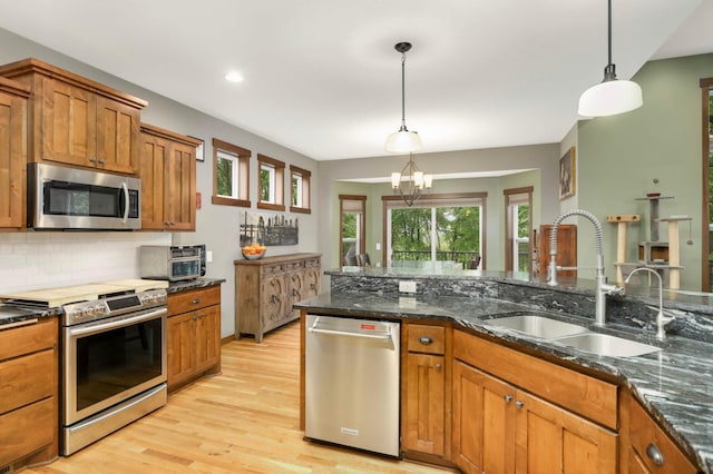 2349 175th Ln NE, Ham Lake, MN 55304 - kitchen with appliances with stainless steel finishes, a sink, brown cabinets, light wood-style floors, and recessed lighting
