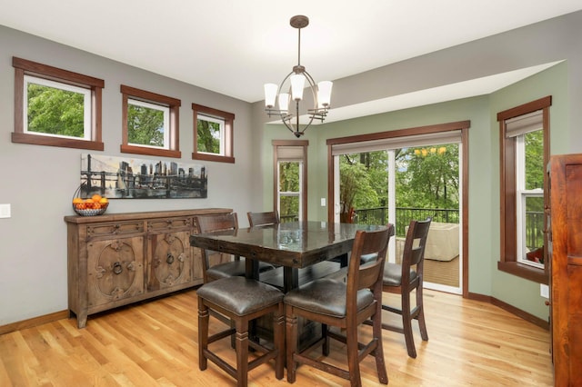 2349 175th Ln NE, Ham Lake, MN 55304 - dining space with a chandelier, light wood finished floors, and baseboards