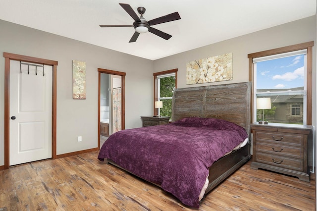 2349 175th Ln NE, Ham Lake, MN 55304 - bedroom with wood finished floors, baseboards, a ceiling fan, and ensuite bathroom