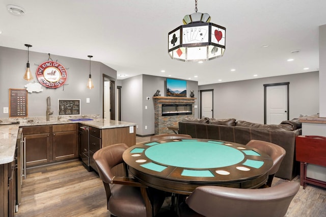 2349 175th Ln NE, Ham Lake, MN 55304 - rec room with light wood-style flooring, a glass covered fireplace, and a sink