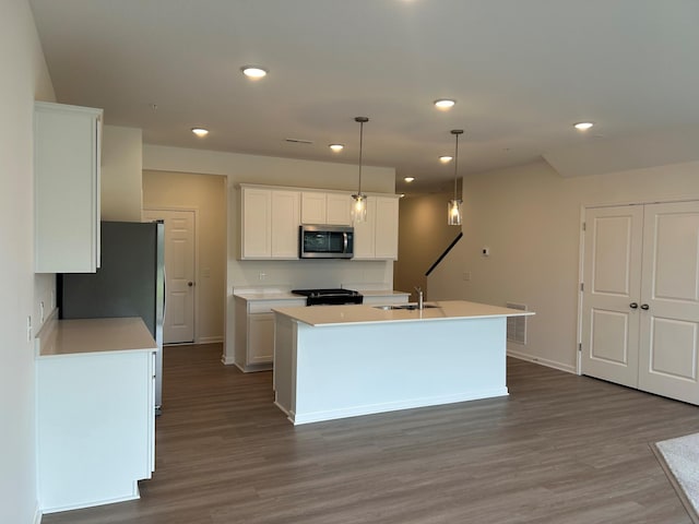 10385 Glacier Ln N, Maple Grove, MN 55369 - kitchen with stainless steel appliances, a sink, dark wood-type flooring, white cabinets, and recessed lighting