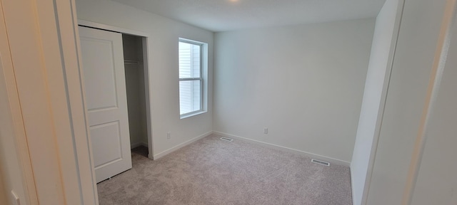 10385 Glacier Ln N, Maple Grove, MN 55369 - unfurnished bedroom featuring multiple windows, light carpet, baseboards, and a closet