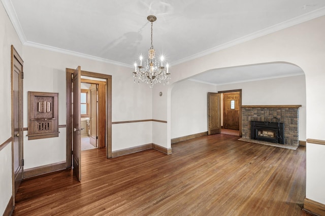 1928 Cleveland St NE, Minneapolis, MN 55418 - unfurnished living room featuring wood finished floors, arched walkways, baseboards, and ornamental molding