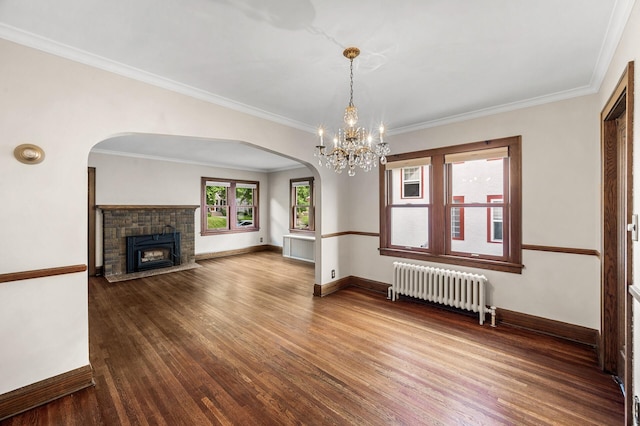 1928 Cleveland St NE, Minneapolis, MN 55418 - unfurnished living room featuring radiator, wood finished floors, arched walkways, baseboards, and ornamental molding