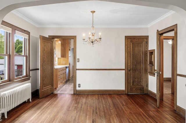 1928 Cleveland St NE, Minneapolis, MN 55418 - unfurnished dining area with radiator, wood finished floors, arched walkways, baseboards, and a chandelier