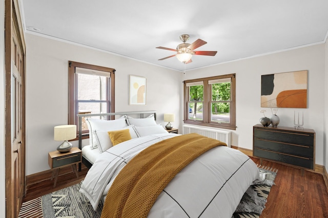 1928 Cleveland St NE, Minneapolis, MN 55418 - bedroom featuring radiator, ornamental molding, wood finished floors, baseboards, and ceiling fan