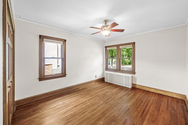 1928 Cleveland St NE, Minneapolis, MN 55418 - empty room featuring radiator heating unit, wood finished floors, ornamental molding, ceiling fan, and baseboards