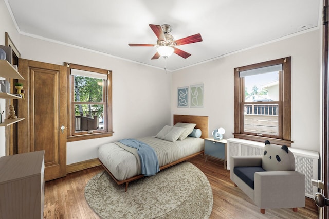 1928 Cleveland St NE, Minneapolis, MN 55418 - bedroom featuring crown molding, light wood-style floors, baseboards, and a ceiling fan