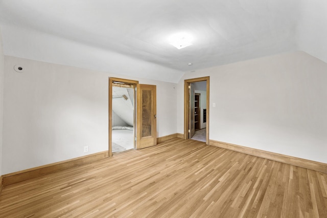 1928 Cleveland St NE, Minneapolis, MN 55418 - empty room with lofted ceiling, light wood-style floors, and baseboards