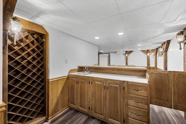 1928 Cleveland St NE, Minneapolis, MN 55418 - indoor bar with a drop ceiling, dark wood-style floors, a wainscoted wall, wooden walls, and recessed lighting