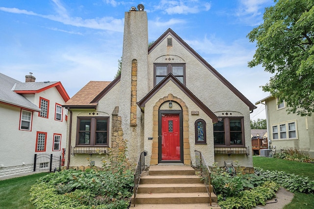 1928 Cleveland St NE, Minneapolis, MN 55418 - view of front of property featuring a chimney and cooling unit