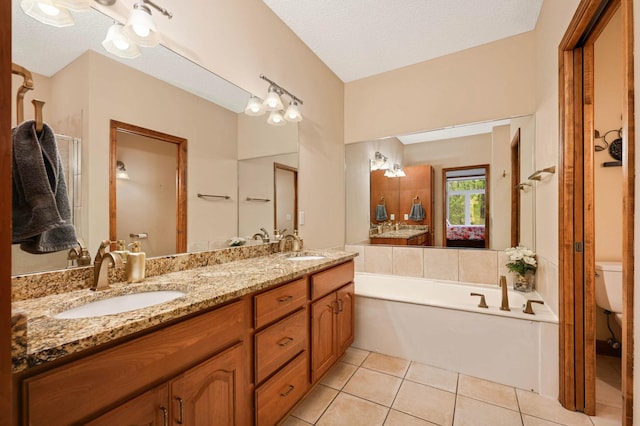 14550 Hunters Ln, Savage, MN 55378 - ensuite bathroom with toilet, double vanity, a garden tub, tile patterned flooring, and a textured ceiling