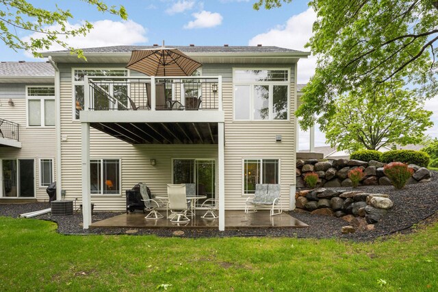 14550 Hunters Ln, Savage, MN 55378 - rear view of property featuring a balcony, a patio, a lawn, and cooling unit