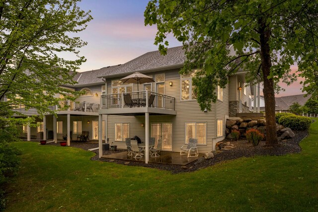 14550 Hunters Ln, Savage, MN 55378 - back of property featuring a lawn, a patio area, a shingled roof, and a balcony