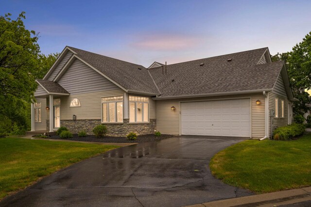 14550 Hunters Ln, Savage, MN 55378 - view of front facade featuring asphalt driveway, a garage, a shingled roof, and a yard