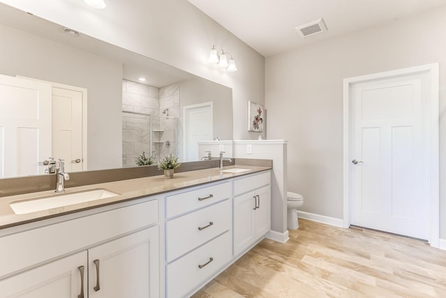 19171 Cottage Rd, Farmington, MN 55024 - bathroom featuring double vanity, a stall shower, toilet, and baseboards
