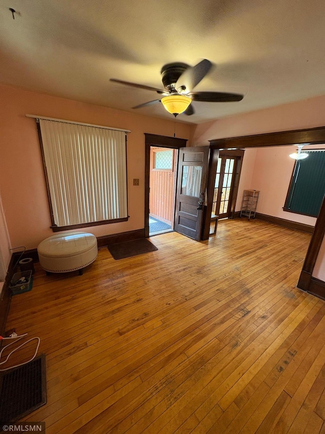 3934 Hubbard Ave N, Robbinsdale, MN 55422 - unfurnished living room featuring a ceiling fan, hardwood / wood-style flooring, and baseboards