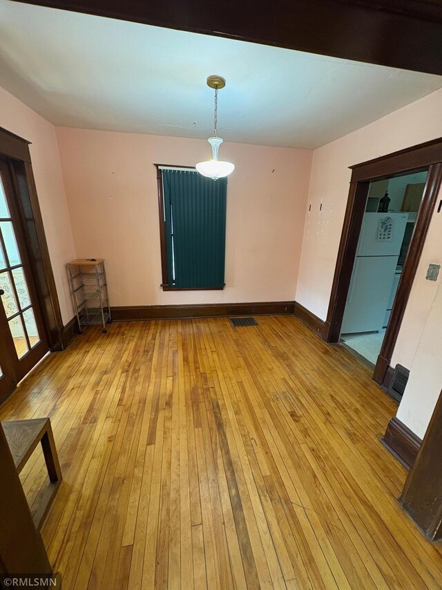 3934 Hubbard Ave N, Robbinsdale, MN 55422 - unfurnished room with wood-type flooring and baseboards
