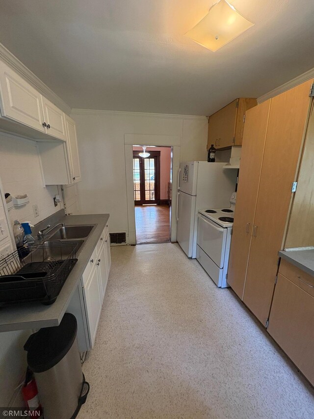 3934 Hubbard Ave N, Robbinsdale, MN 55422 - kitchen with white appliances, under cabinet range hood, a sink, white cabinetry, and french doors