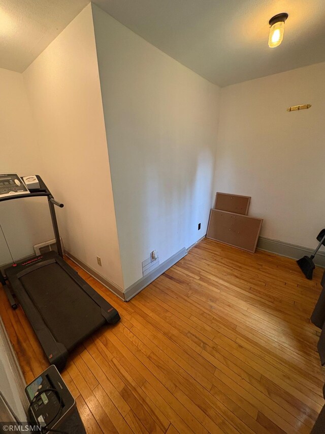 3934 Hubbard Ave N, Robbinsdale, MN 55422 - workout room featuring hardwood / wood-style flooring and baseboards