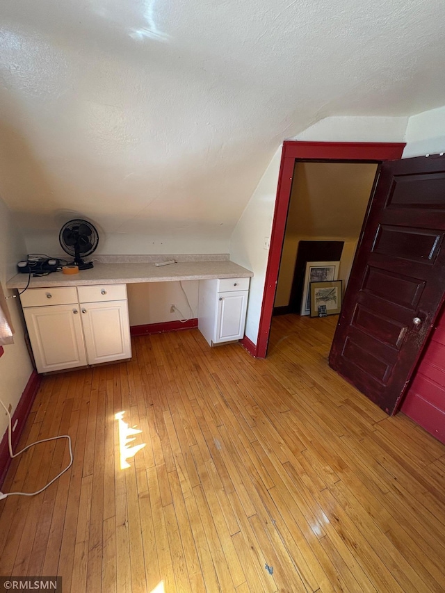 3934 Hubbard Ave N, Robbinsdale, MN 55422 - additional living space featuring light wood-type flooring, baseboards, and a textured ceiling
