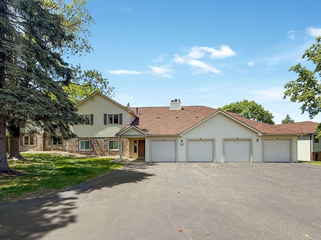 1871 Livingston Ave Unit C, West Saint Paul, MN 55118 - townhome / multi-family property featuring driveway, an attached garage, a chimney, brick siding, and a front lawn