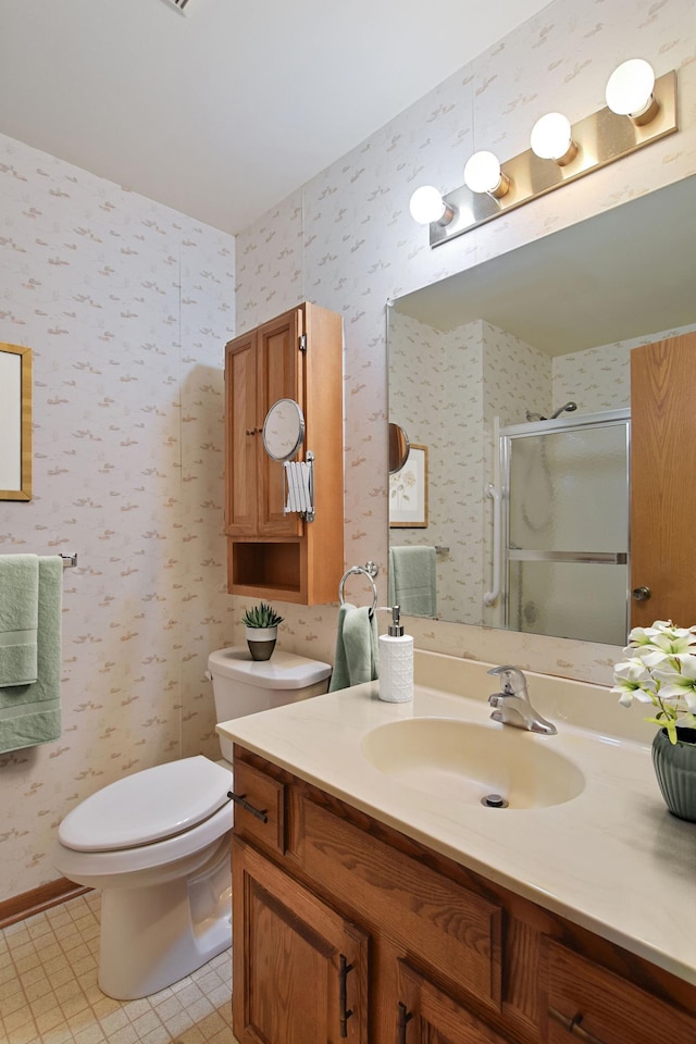 1871 Livingston Ave Unit C, West Saint Paul, MN 55118 - bathroom featuring vanity, a shower stall, toilet, and wallpapered walls