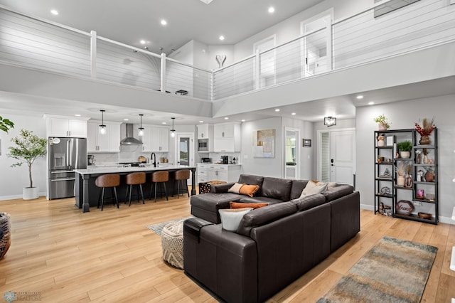 4533 38 1/2 Ave N, Reiles Acres, ND 58102 - living room with a high ceiling, baseboards, light wood finished floors, and recessed lighting
