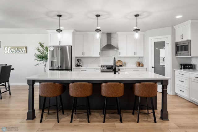 4533 38 1/2 Ave N, Reiles Acres, ND 58102 - kitchen featuring stainless steel appliances, wall chimney exhaust hood, backsplash, white cabinetry, and recessed lighting