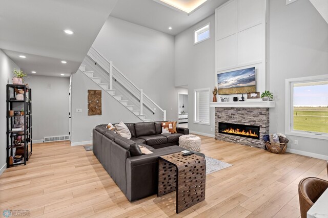 4533 38 1/2 Ave N, Reiles Acres, ND 58102 - living room with light wood-type flooring, stairs, baseboards, plenty of natural light, and a towering ceiling