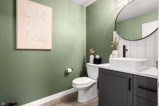 4533 38 1/2 Ave N, Reiles Acres, ND 58102 - bathroom with vanity, toilet, tile patterned flooring, baseboards, and decorative backsplash