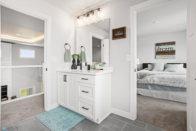 4533 38 1/2 Ave N, Reiles Acres, ND 58102 - ensuite bathroom featuring vanity, tile patterned flooring, and baseboards