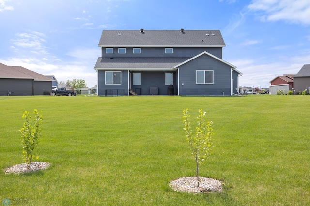 4533 38 1/2 Ave N, Reiles Acres, ND 58102 - back of property featuring a yard and roof with shingles