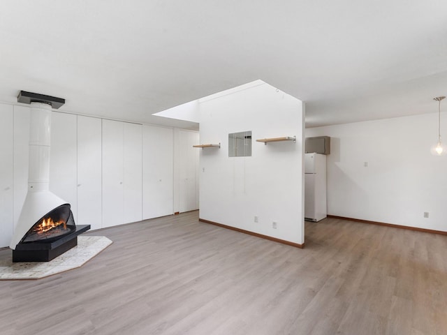 26 Arthur Ave SE Unit 304, Minneapolis, MN 55414 - unfurnished living room featuring light wood-style floors and baseboards