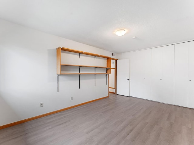 26 Arthur Ave SE Unit 304, Minneapolis, MN 55414 - unfurnished bedroom featuring light wood-style floors and baseboards