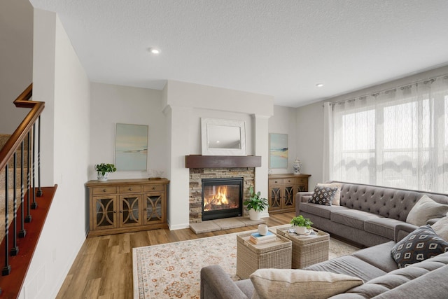 1721 Pebblestone Rd, Carver, MN 55315 - living room featuring wood finished floors, a fireplace, recessed lighting, and baseboards