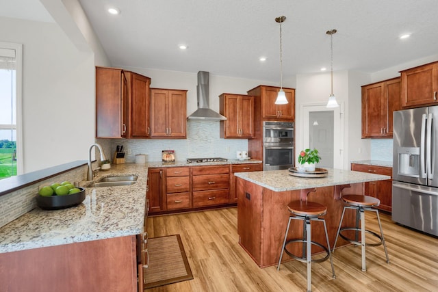 1721 Pebblestone Rd, Carver, MN 55315 - kitchen with appliances with stainless steel finishes, wall chimney exhaust hood, a sink, light stone countertops, and recessed lighting